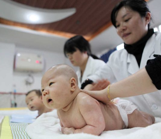 Chinese children playing in a park as the government offers birth incentives to support families