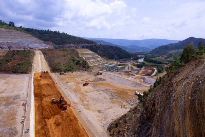 Nyabarongo II Dam under construction with machinery and water channels visible