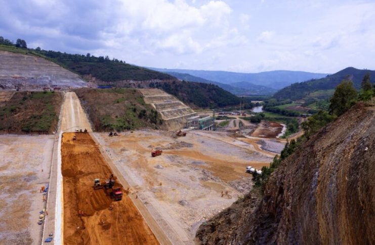 Nyabarongo II Dam under construction with machinery and water channels visible
