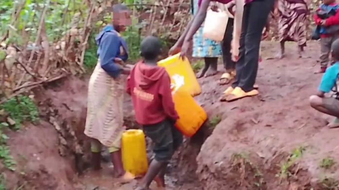 Rusizi residents walking in a village area without water and electricity.