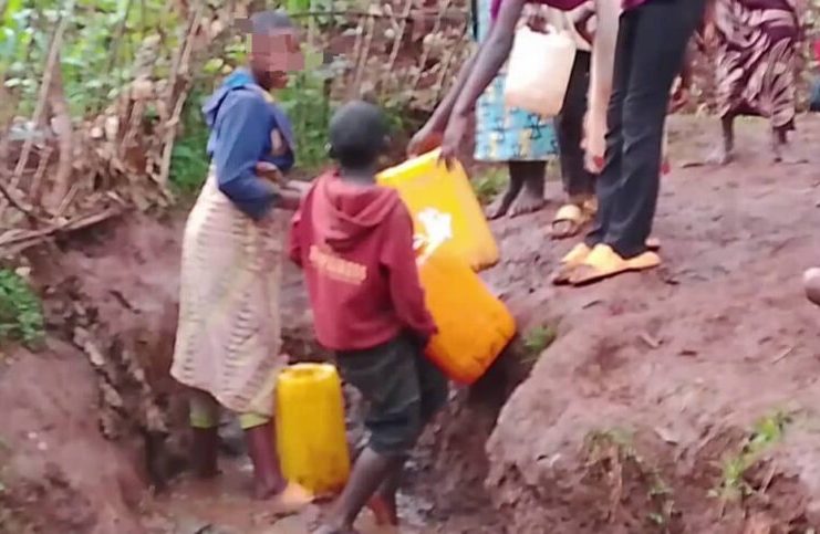 Rusizi residents walking in a village area without water and electricity.
